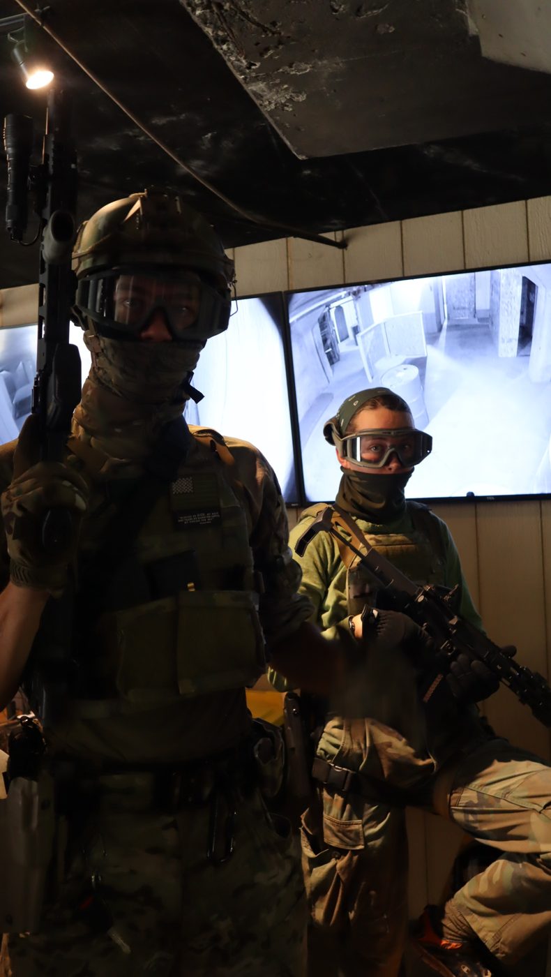 Two players in helmets, goggles and tactical gear
