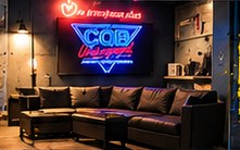 The viewing lobby with couches and the neon CQB Underground sign