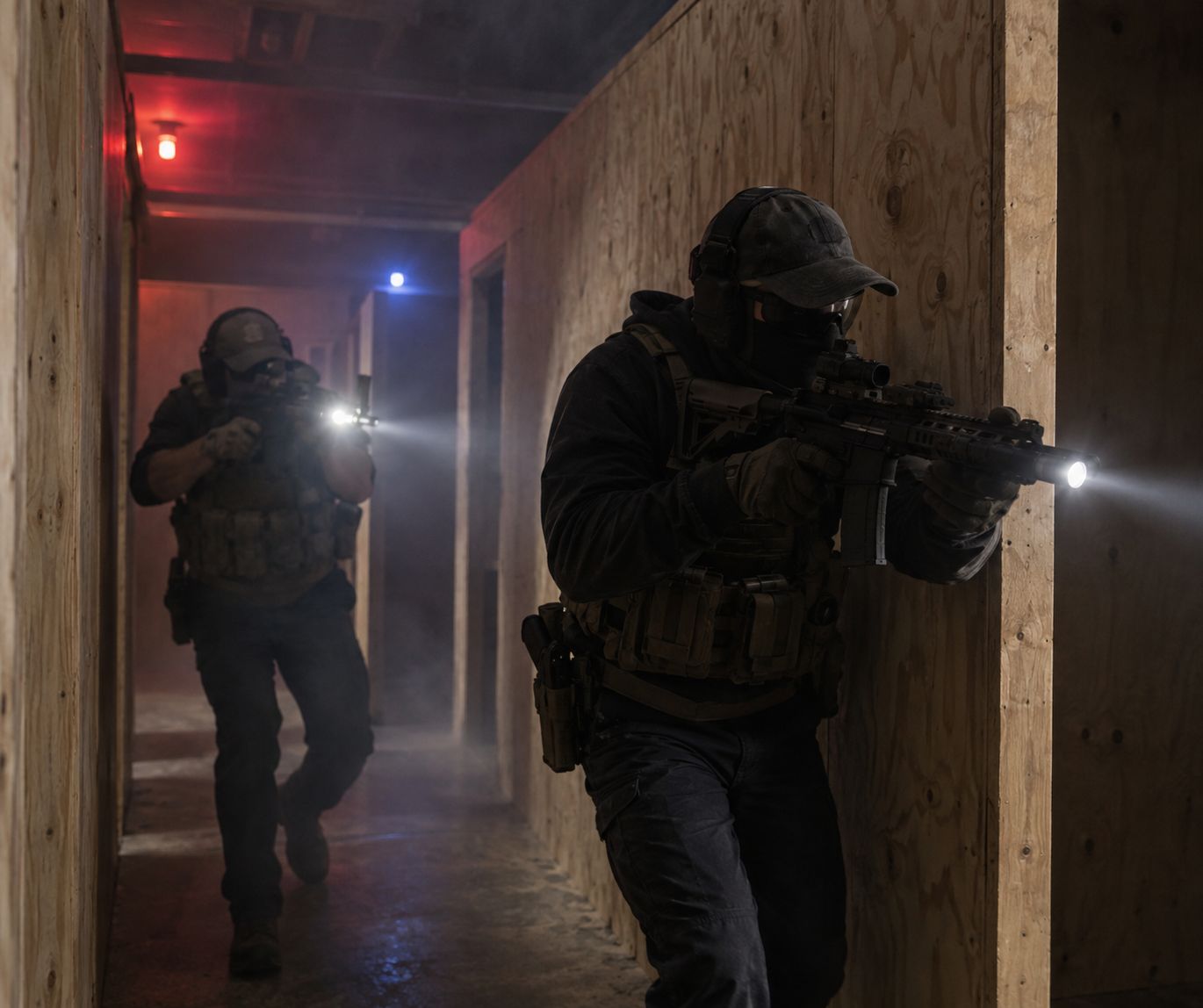 Two operators clearing a hallway corner with weapon lights